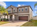 Beautiful exterior featuring manicured landscaping, an attached two-car garage, and a welcoming front entrance at 19429 Paddock View Dr, Tampa, FL 33647