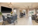 Open-concept dining room featuring modern lighting, sleek flooring, and seamless flow to the outdoor patio at 2619 Ravendale Ln, Holiday, FL 34691