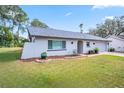 Charming single-story home with well-manicured lawn and an attached two-car garage on a sunny day at 3373 Brodie Way, Palm Harbor, FL 34684