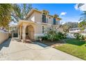 Two-story home featuring a stucco exterior, wrought iron gate, and a long driveway at 4810 W San Miguel St, Tampa, FL 33629