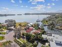 Stunning aerial view of a waterfront property with lush landscaping and access to the open bay at 4811 Paradise S Way, St Petersburg, FL 33705