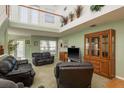 Spacious living room with high ceilings, natural light, and comfortable leather seating at 512 Oceanview Ave, Palm Harbor, FL 34683