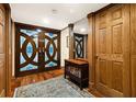 A grand entryway featuring decorative wood doors, hardwood floors, and elegant furnishings at 5701 Mariner St # 606, Tampa, FL 33609