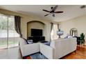 Cozy living room featuring hardwood floors, archway, and a comfortable seating arrangement with ample light at 7510 Red Mill Cir, New Port Richey, FL 34653