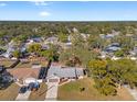 A beautiful aerial view of the home surrounded by mature trees in a quiet neighborhood at 8449 Valmora St, Spring Hill, FL 34608