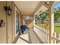 Cozy front porch featuring a comfortable chair and a view of the lush front yard at 8449 Valmora St, Spring Hill, FL 34608