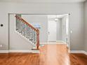 Inviting foyer with hardwood floors, staircase with iron spindles, and lots of natural light at 10193 Grand Oak Cir, Madeira Beach, FL 33708