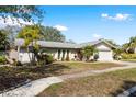 Well-maintained single-story home featuring a beautifully landscaped front yard at 10222 95Th St, Seminole, FL 33777