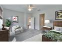 Cozy main bedroom with plush carpeting, neutral tones, and a decorative ceiling fan at 11542 Captiva Kay Dr, Riverview, FL 33569