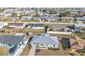 Aerial view of a single story home with a metal roof nestled in a residential neighborhood at 13526 Alberta Ave, Port Charlotte, FL 33981