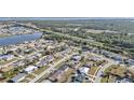 Panoramic aerial view of a residential neighborhood near a body of water and green areas at 13526 Alberta Ave, Port Charlotte, FL 33981