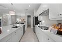 Bright kitchen featuring white cabinets, stainless steel appliances, and a large island at 17020 Cape Horn Blvd, Punta Gorda, FL 33955