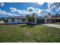 Well-maintained single-story home with a spacious front lawn and inviting curb appeal at 17319 Terry Ave, Port Charlotte, FL 33948