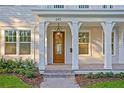 Inviting front porch featuring classic columns, a stylish hanging lantern, and a brick pathway at 243 28Th N Ave, St Petersburg, FL 33704