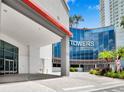 Inviting Towers entrance with palm trees and covered drop-off offers a glimpse of the building's modern design at 449 S 12Th St # 1105, Tampa, FL 33602