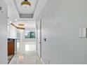 Bright hallway with tile floors and elegant lighting leads into living area with city views at 449 S 12Th St # 1105, Tampa, FL 33602