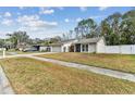 View of a charming home with a well-maintained front yard and driveway at 4504 Grainary Ave, Tampa, FL 33624