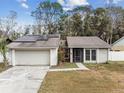 Inviting single-Gathering home featuring solar panels and a screened front entry at 4504 Grainary Ave, Tampa, FL 33624