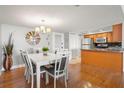 Open-concept space with a dining area featuring a table with seating adjacent to a kitchen area with stainless appliances at 500 Treasure Island Cswy # 404, Treasure Island, FL 33706