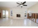 Living room view showcasing a stone fireplace and tiled flooring undergoing renovations at 7623 Mako Dr, Hudson, FL 34667