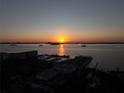 Scenic sunset view over the ocean, buildings, and boats at 817 Wilkie St, Dunedin, FL 34698