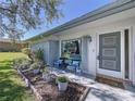 Charming front porch featuring comfortable seating, beautiful plants, and a welcoming entryway to the home at 10525 Mira Vista Dr, Port Richey, FL 34668