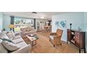 Bright, coastal living room with water views, comfortable seating, and an open floor plan with tile floors at 13614 Evelane Dr, Hudson, FL 34667