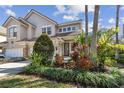 Beautiful two-story home featuring an attached garage and professionally landscaped front yard at 14541 Mirabelle Vista Cir, Tampa, FL 33626