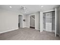 Neutral bedroom with plush carpet, built-in closet organizers, and ample lighting at 2571 W Platt St, Tampa, FL 33609