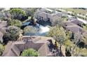 Scenic aerial view of the community showcasing lush landscaping, mature trees, and a serene pond at 2689 Sabal Springs Cir # 103, Clearwater, FL 33761