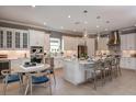 Bright, open kitchen featuring a central island with seating and stainless steel appliances at 29924 Rusco Ct, Wesley Chapel, FL 33545