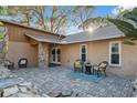 Spacious paved patio ideal for outdoor entertaining, enhanced by stone accents and comfortable seating at 3092 Osprey Ln, Clearwater, FL 33762