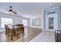 A spacious dining room featuring wood floors, a decorative ceiling, and a light blue wall at 3133 Beaver Pond Trl, Valrico, FL 33596