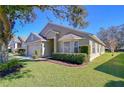 A single-story home featuring manicured landscaping, green grass, and large windows at 3133 Beaver Pond Trl, Valrico, FL 33596