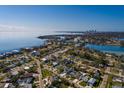 Scenic aerial view of a waterfront neighborhood showcasing a charming turquoise home with beautiful waterfront views at 3774 Arkansas Ne Ave, St Petersburg, FL 33703