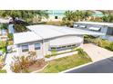 Charming home with large carport, featuring manicured lawn and mature landscaping at 37841 Mission Hills Ave, Zephyrhills, FL 33541