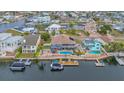 Waterfront home featuring a backyard pool, dock and boat lift, ideal for boating enthusiasts at 4195 Des Prez Ct, Hernando Beach, FL 34607