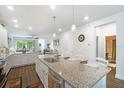 Spacious kitchen with a large granite countertop island with sink and seating at 5566 Silver Sun Dr, Apollo Beach, FL 33572