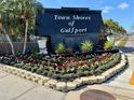 Well-maintained community sign with vibrant flower beds and lush greenery at 5980 Shore S Blvd # 510, Gulfport, FL 33707