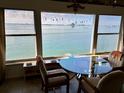 Stunning water view from a window with a table and chairs at 5980 Shore S Blvd # 510, Gulfport, FL 33707