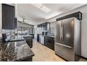 Modern kitchen featuring granite countertops and stainless steel appliances at 7911 Floradora Dr, New Port Richey, FL 34654