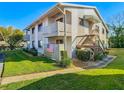 Condo exterior with wooden staircases, a small balcony and green lawn at 8024 Feather Ct # D, Hudson, FL 34667