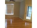 Bright living room featuring hardwood floors, neutral walls, and a glass door at 9404 Crescent Loop Cir # 104, Tampa, FL 33619