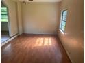 Living room with wood-look floors and a large window offering natural light at 9707 Lithia Pinecrest Rd, Lithia, FL 33547