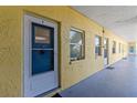 Inviting condo exterior with a well-lit hallway and yellow facade at 9895 1St E St # 5, Treasure Island, FL 33706