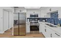 Modern kitchen with white cabinets, stainless steel appliances, and subway tile backsplash at 9895 1St E St # 5, Treasure Island, FL 33706