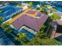 Aerial view showcasing the home's orange tile roof, screened-in pool, and surrounding neighborhood at 109 Live Oak Ln, Largo, FL 33770