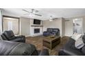 Bright living room with a fireplace, hardwood floors, and comfortable seating at 1404 Wood Ave, Clearwater, FL 33755