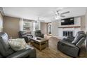 Spacious living room with fireplace, modern ceiling fans, and natural light at 1404 Wood Ave, Clearwater, FL 33755