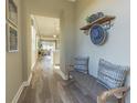 A hallway with a charming entryway bench adds character to this cozy home's interior design at 14466 Pioneer Ridge Dr, Hudson, FL 34667
